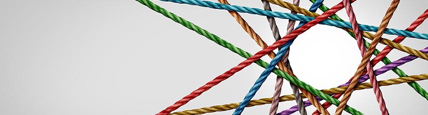 Colourful ropes crossing over one another forming a circle with intersecting lines around it and a plain grey background. 