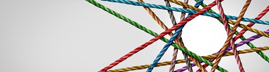 Colourful ropes crossing over one another forming a circle with intersecting lines around it and a plain grey background.