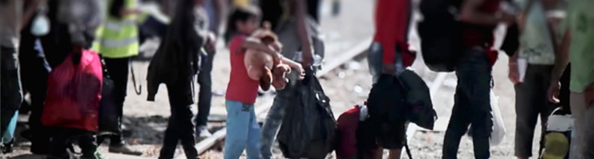 Refugees of all ages walking with bags