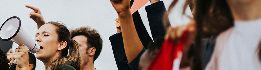 People protesting, woman with a megaphone