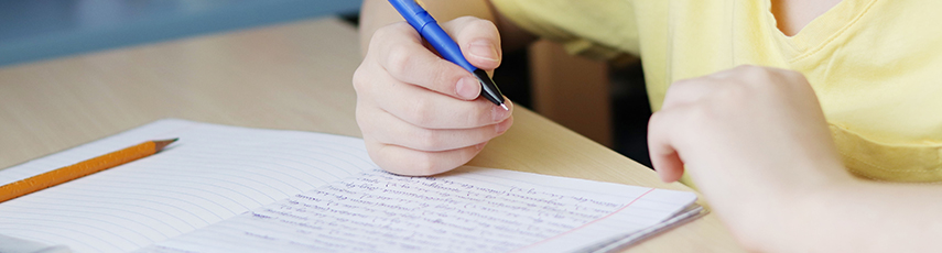 Child writing in an exercise book