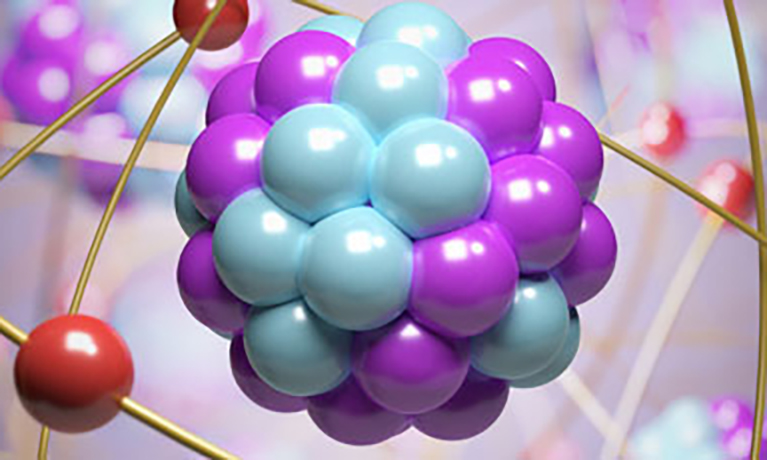 Blue and purple balls in a cluster, representing an atom