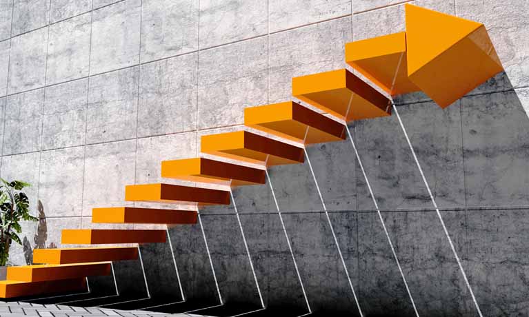 orange staircase with arrow sign and concrete wall in exterior scene