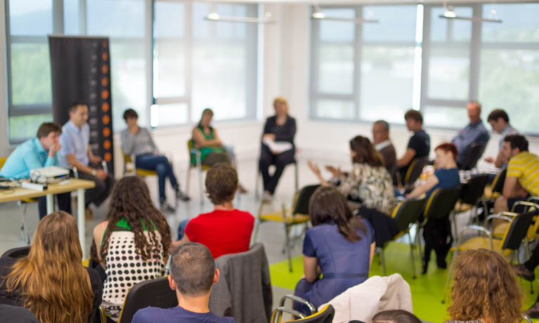 people sitting on chairs in conference room