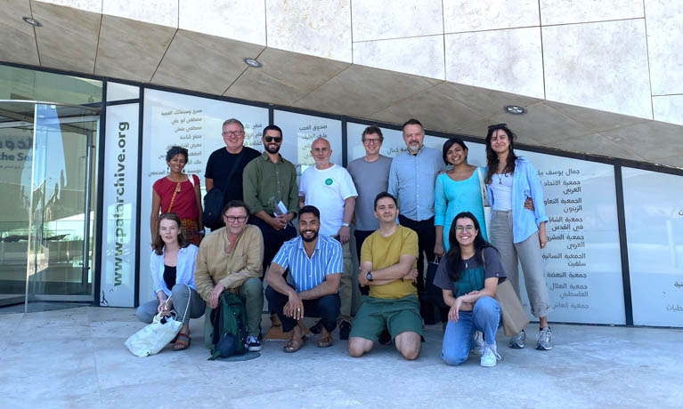 Group of over 10 researchers stood outside education institute in Palestine