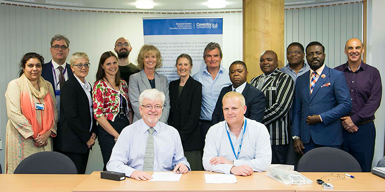 Group of delegates sat behind Professor Robert Midgely and Professor Richard Dashwood 