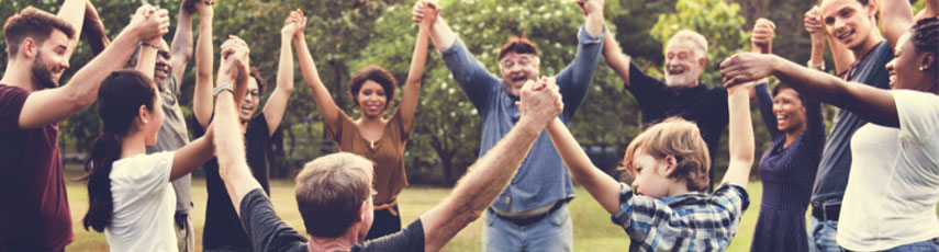Group of people holding hand together in the park