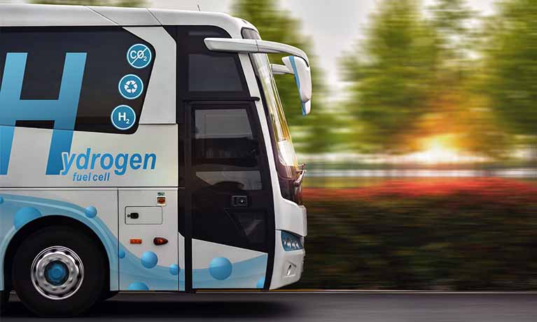 Front of Hydrogen powered coach on road.