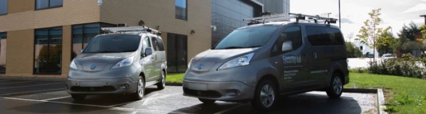 two grey Nissan cars with Coventry University branding in a car park