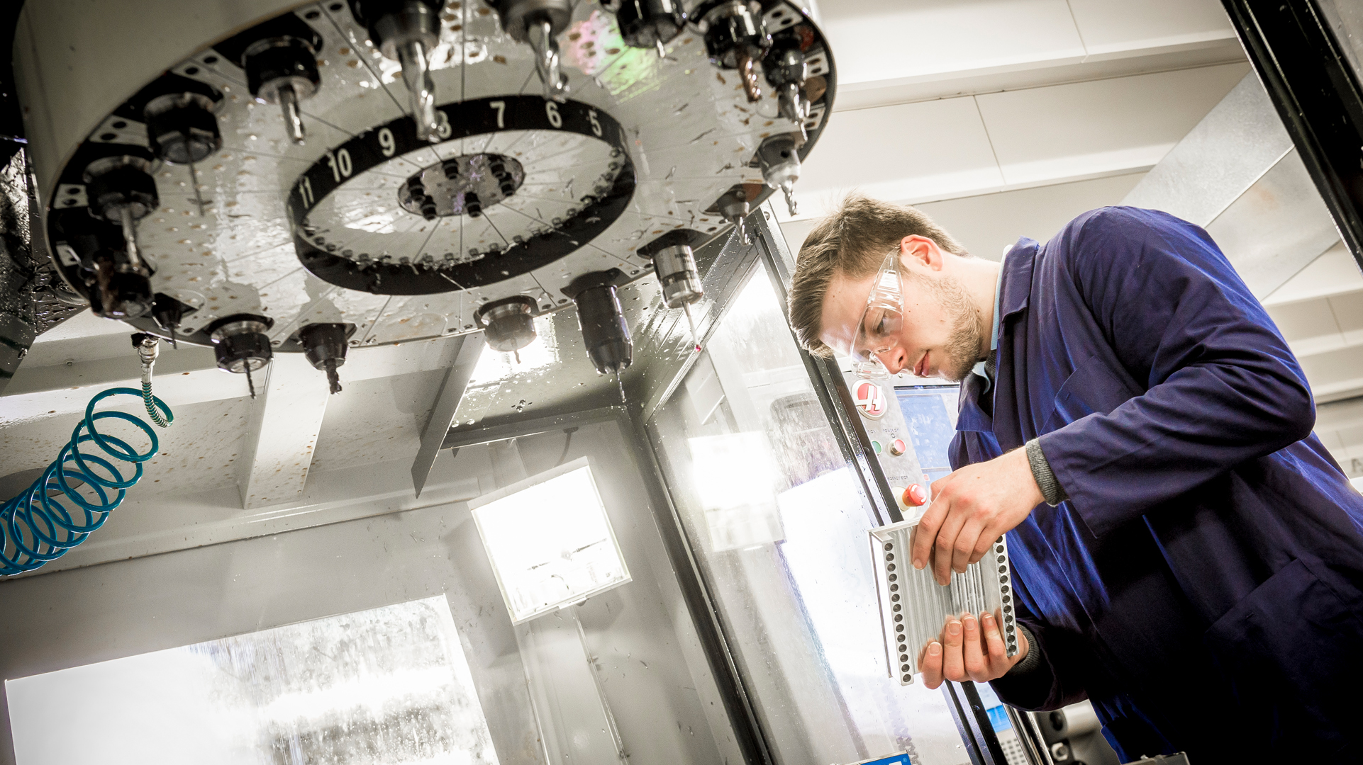 A student working on an engine part.