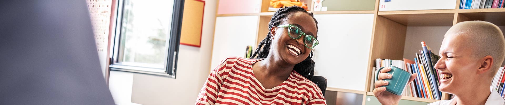 Staff chatting and laughing over a cup of tea