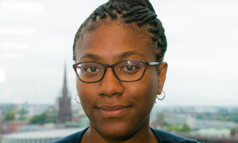 Dr Cherisse Hoyte, pictured against the Coventry skyline with the Cathedral behind her.