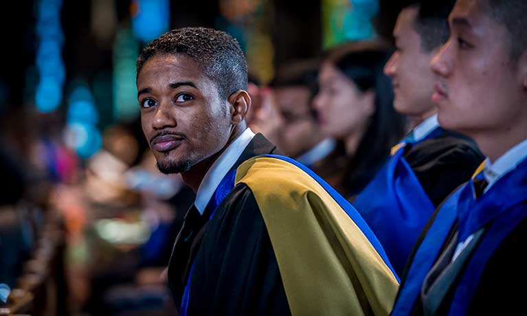 male student at graduation male asian student at graduation