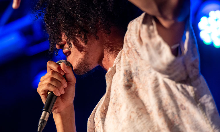 Person close up singing into a microphone