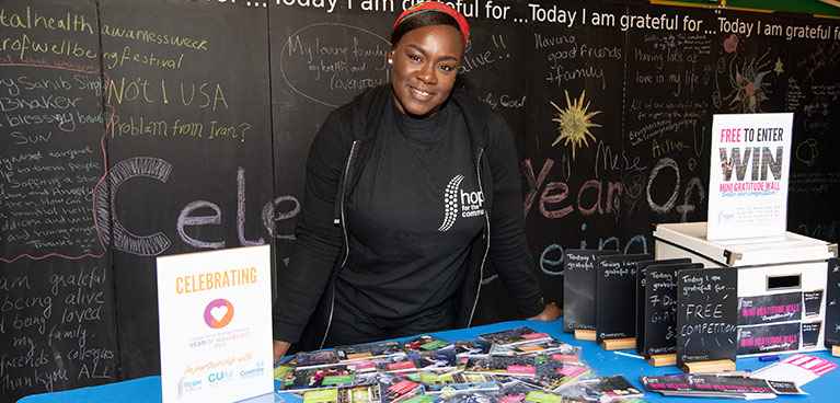 BAME staff member at a stall at a wellbeing event