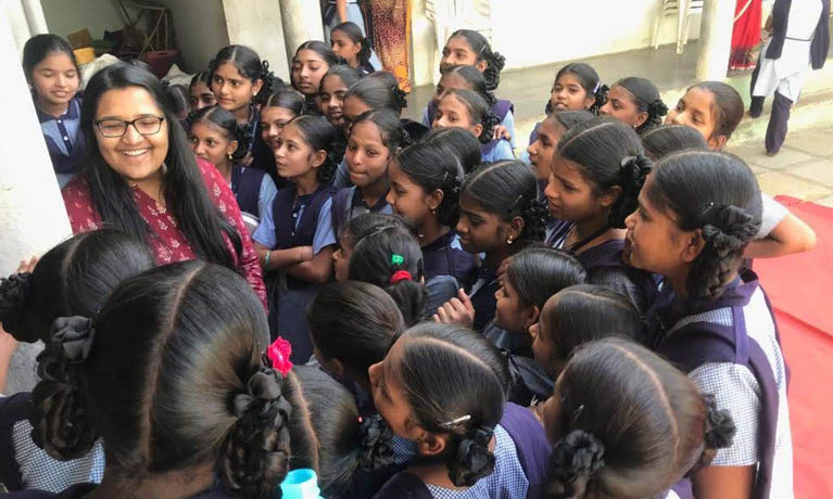 Pavani with group of pupils outside school.