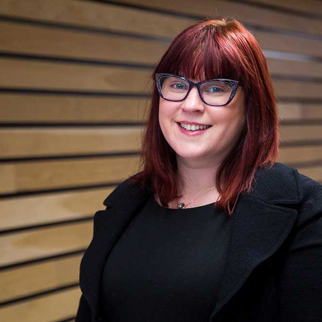 Redhead lady wearing a black jacket