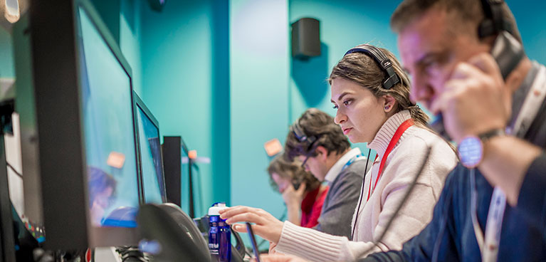 Call centre display with people talking on the phone