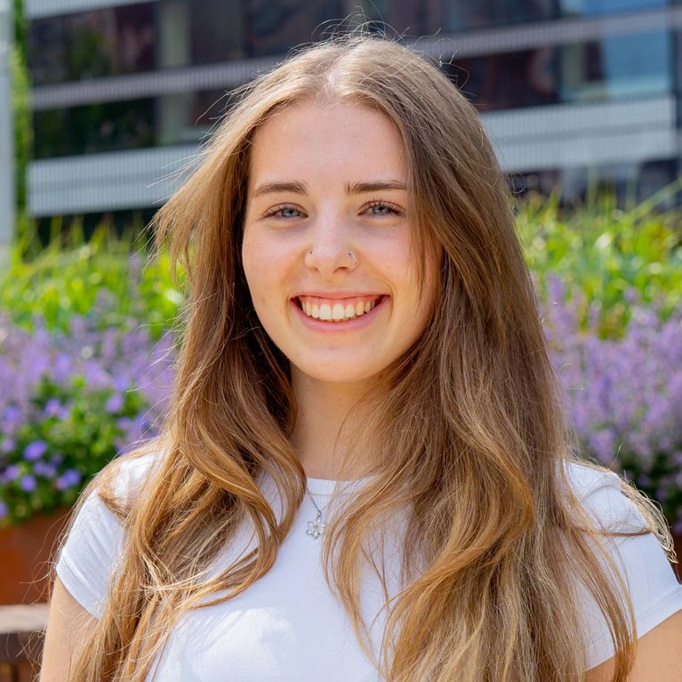 Layna Forbes outside on the Coventry University campus on a sunny day.