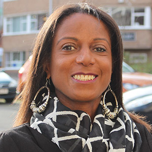 Black mature woman smiling at a camera