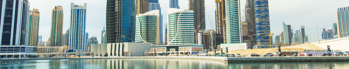 View of the city skyscrapers next to the water in Dubai.