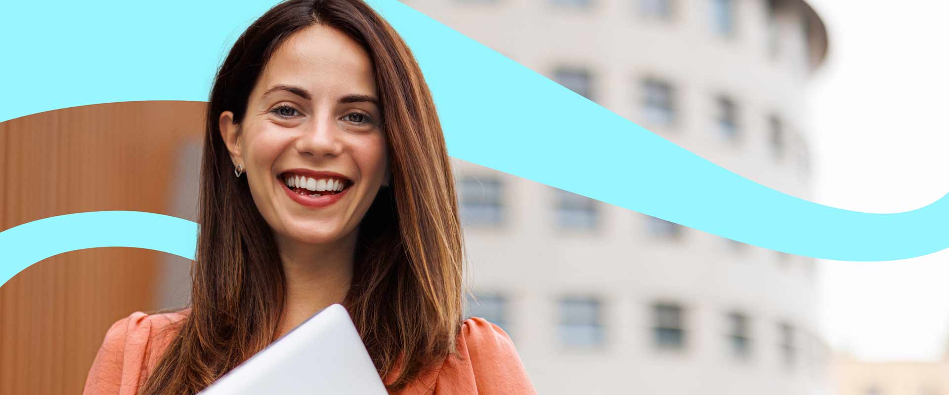 Smiling female with dark long hair holding a laptop with building and light blue swirls in the background