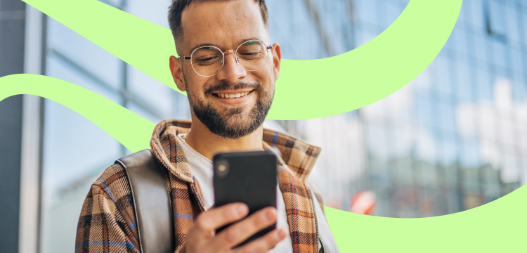 Smiling man looking at a mobile phone 