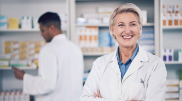 Woman in a white lab coat in a pharmacy