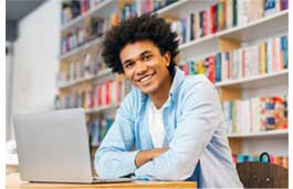 young man sitting in front of a laptop