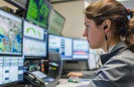 emergency worker looking at multiple screens  