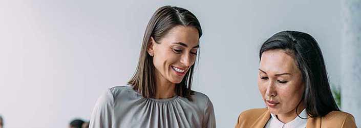Two smartly dressed women chatting