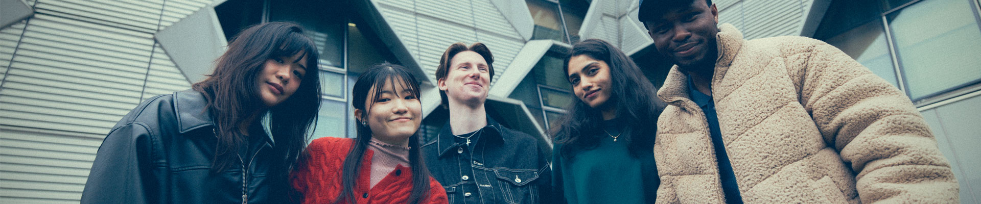 A group of students posing for the camera outside the Engineering building