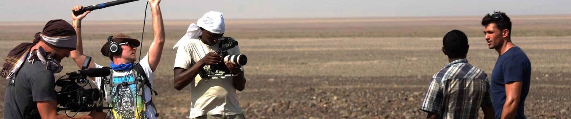 Film crew working in a desert