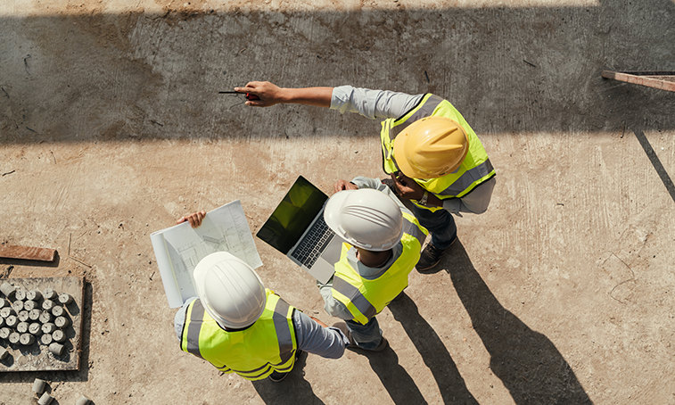 Three people in hi-vis pointing