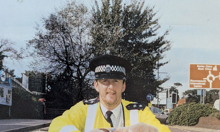 Alan Jenkins smiling outside in his police uniform