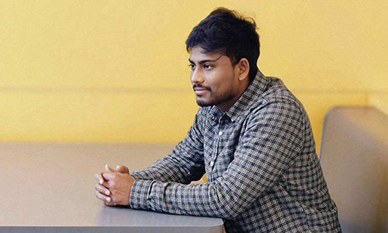 Gopi Parasuraman sitting in a booth in the student hub