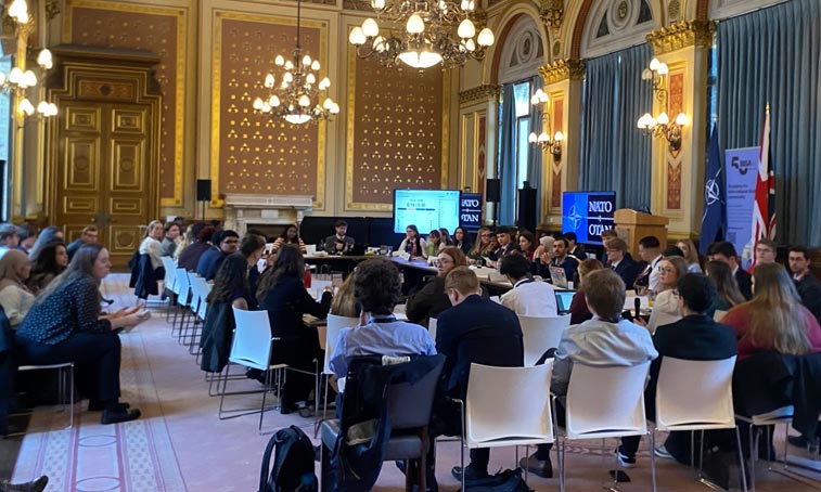 a large group of students sat round a conference table
