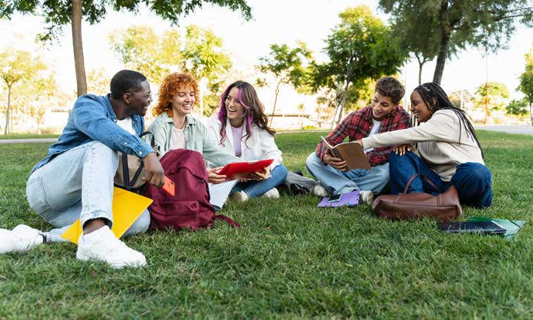group of students sat on grass