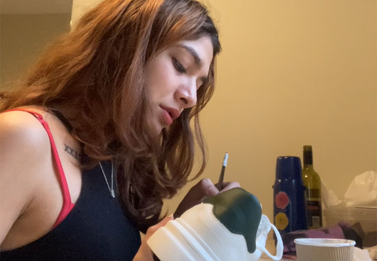 girl painting a sneaker