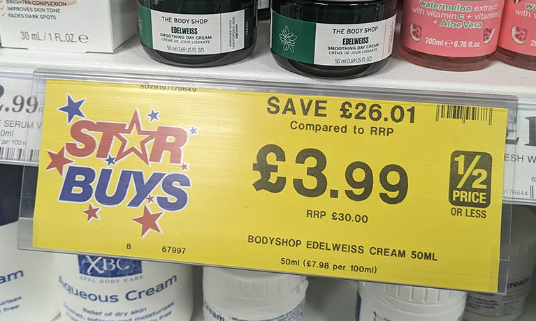 A savings sign in a supermarket in yellow