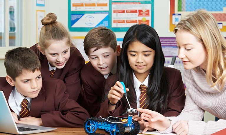 Pupils And Teacher In Science Lesson Studying Robotics