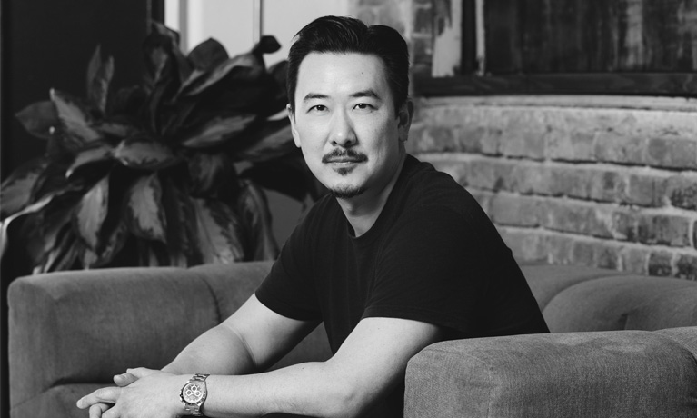 David Imai sat on a sofa in a modern office