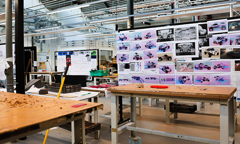interior of a workshop in the Delia Derbyshire building with sketches of various cars