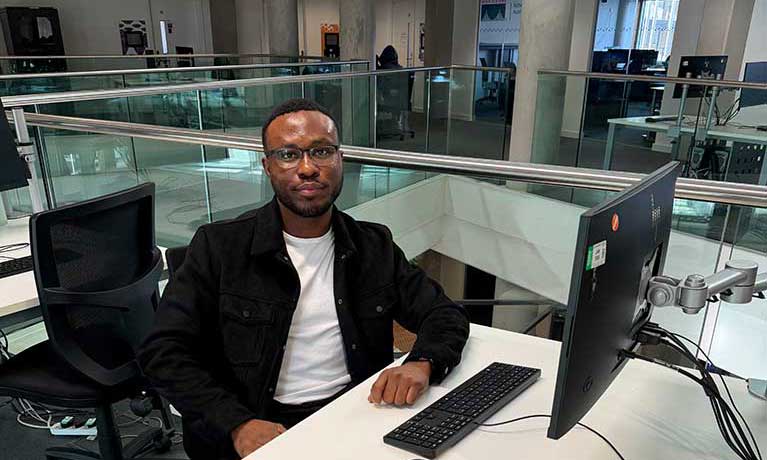 Destiny sitting at a desk in university