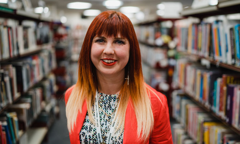 Emilie smiling in a library