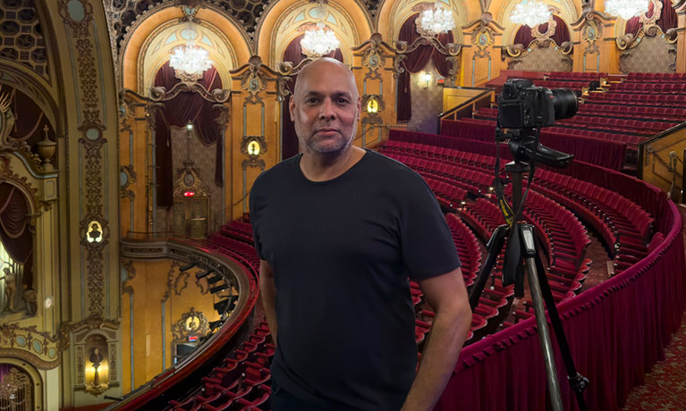 Gavin john posing for a photo in a theatre room