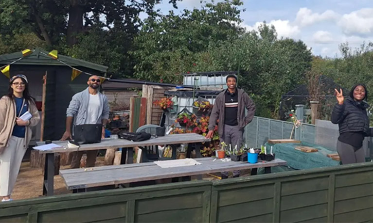 Students standing together in a garden