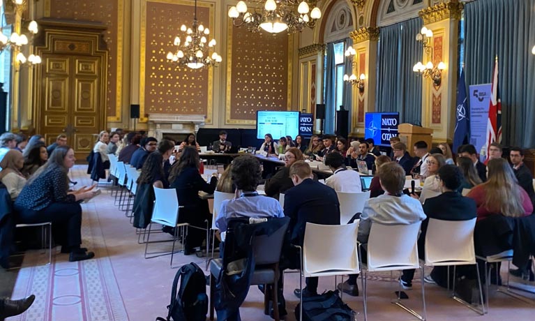 a large group of students sat round a conference table