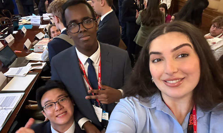 three students smiling in a selfie