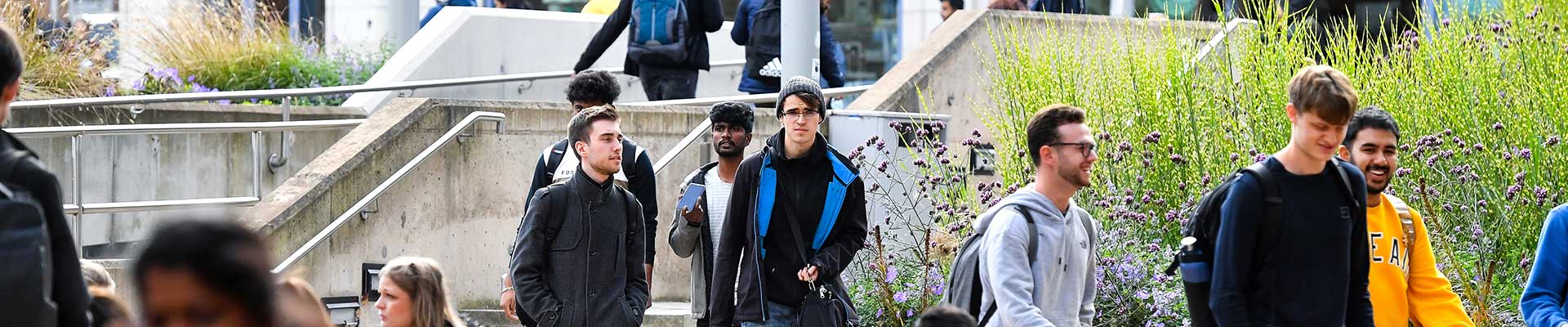 Students walking outside of the the on a clear day